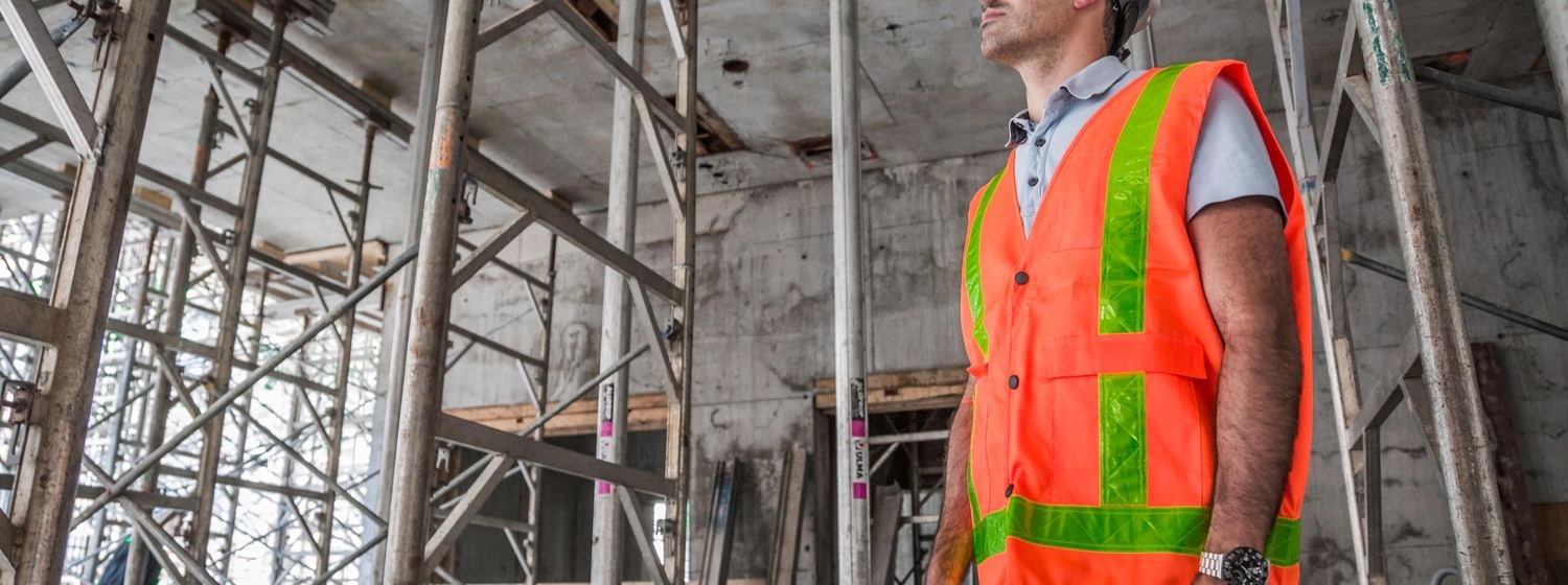 Site supervisor inspecting concrete slab formwork and shoring